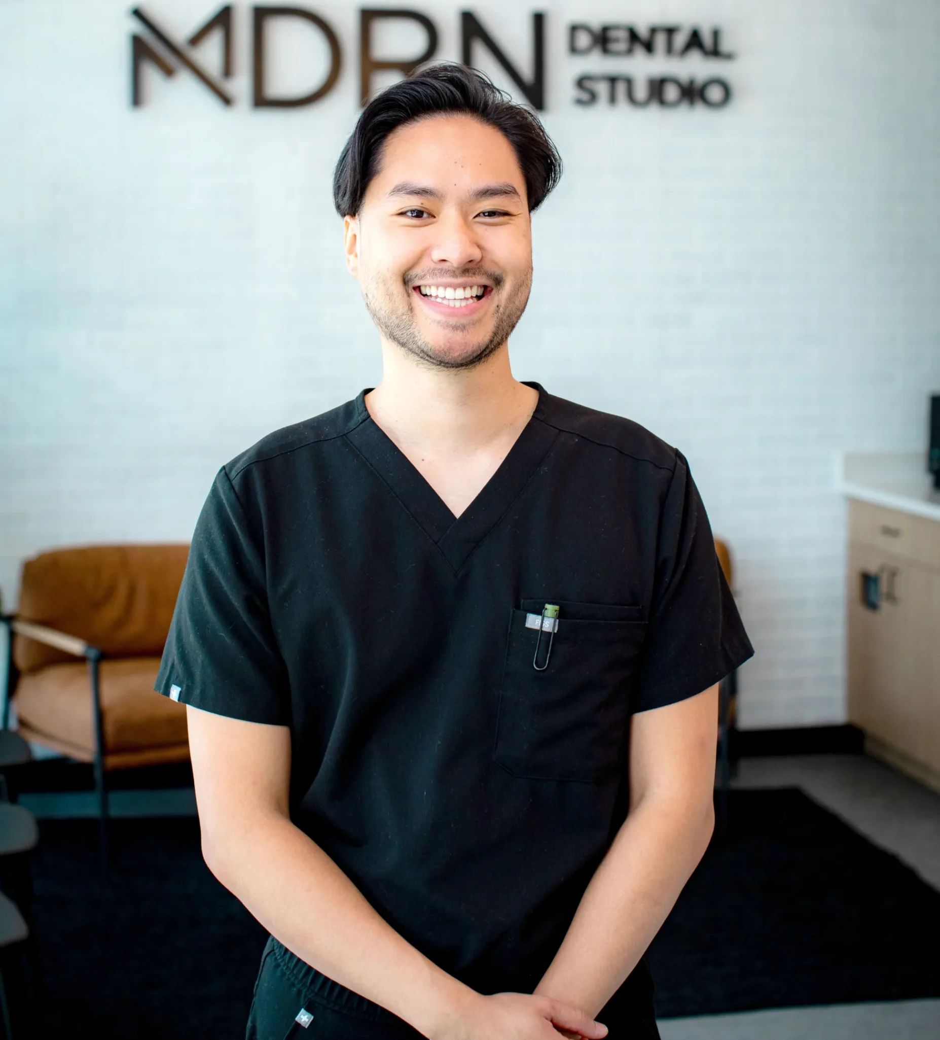 Dr. Steven Nguyen, DDS, smiling in the MDRN Dental Studio treatment room